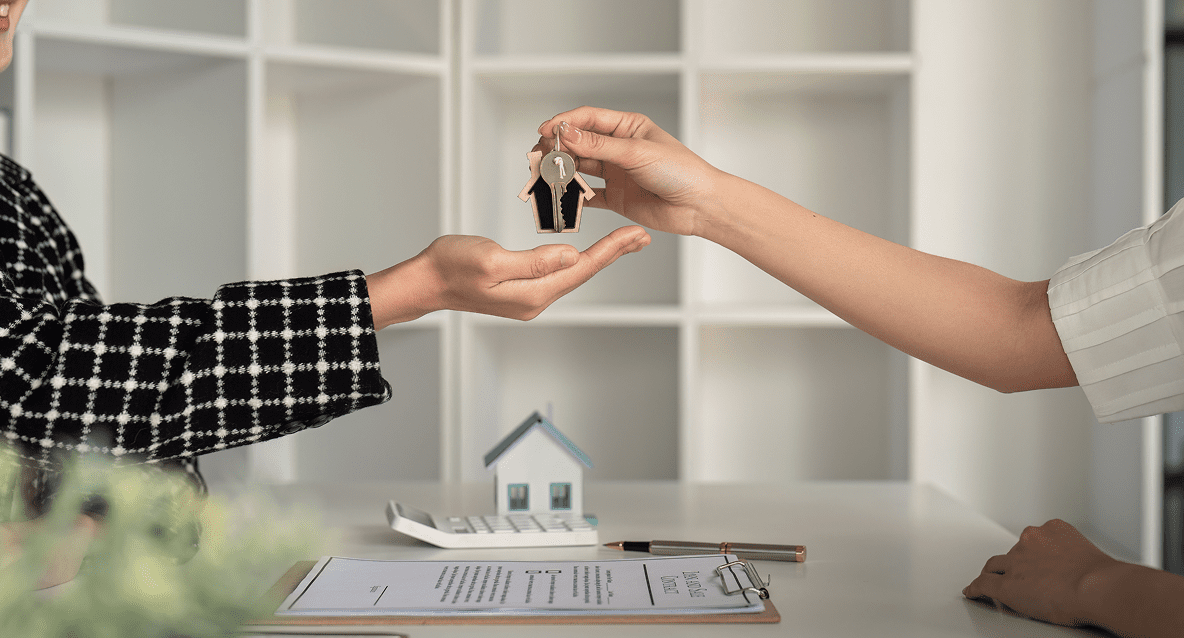 A person handing over keys to another person.